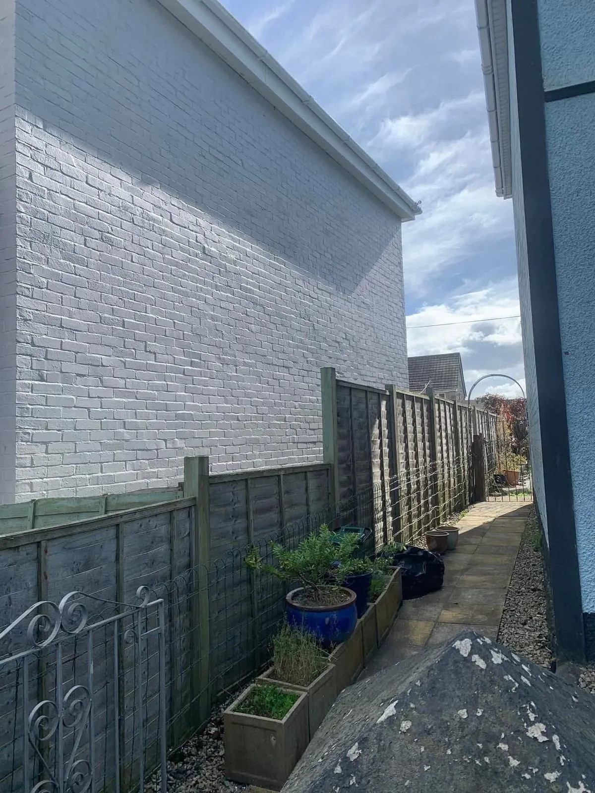 Freshly painted brick wall after preparation and masonry paint in St Agnes