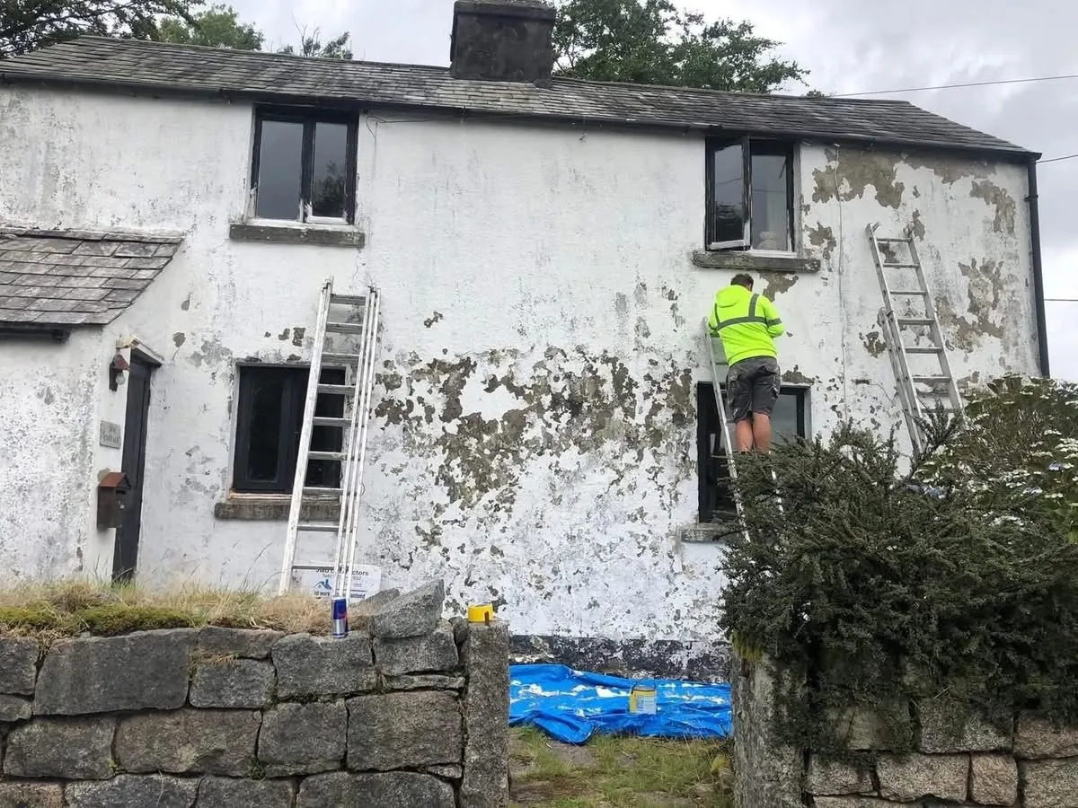 Cottage with blown, flaking render before repair in St Agnes